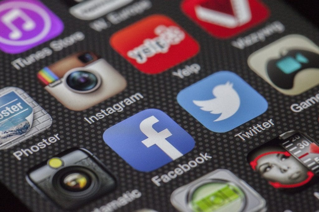 a close up of a phone with social media icons